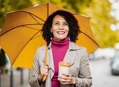 Woman in autumn enjoying her coffee outdoors