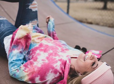 A girl resting on a ramp in a park